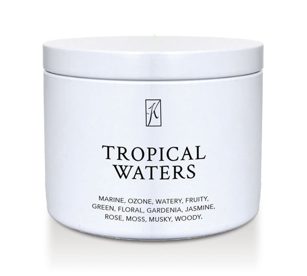 'Tropical Waters' scented candle in a tin container on a white background.
