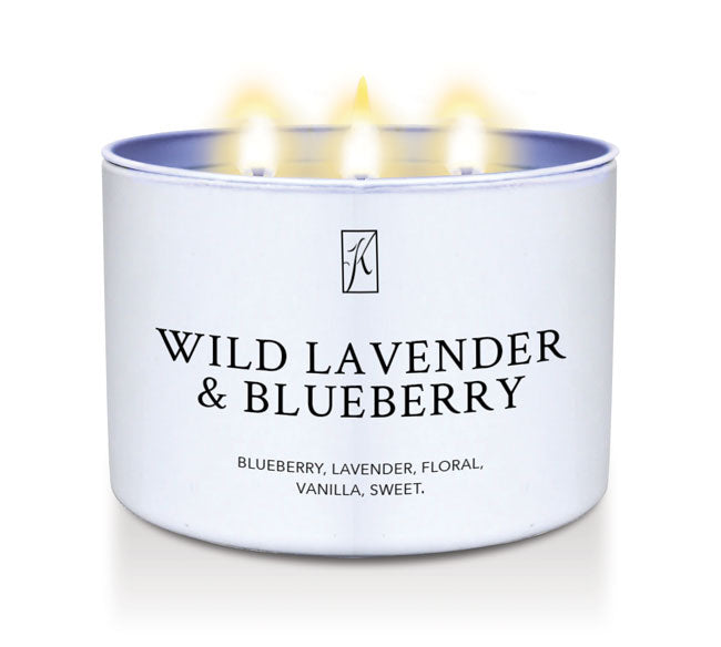 Candle in a white tin container labeled 'Wild Lavender & Blueberry' on a white background