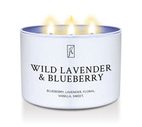 Candle in a white tin container labeled 'Wild Lavender & Blueberry' on a white background