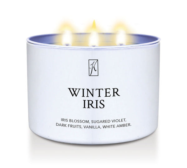 Candle in a white container labeled 'Winter Iris' with a logo on a white background