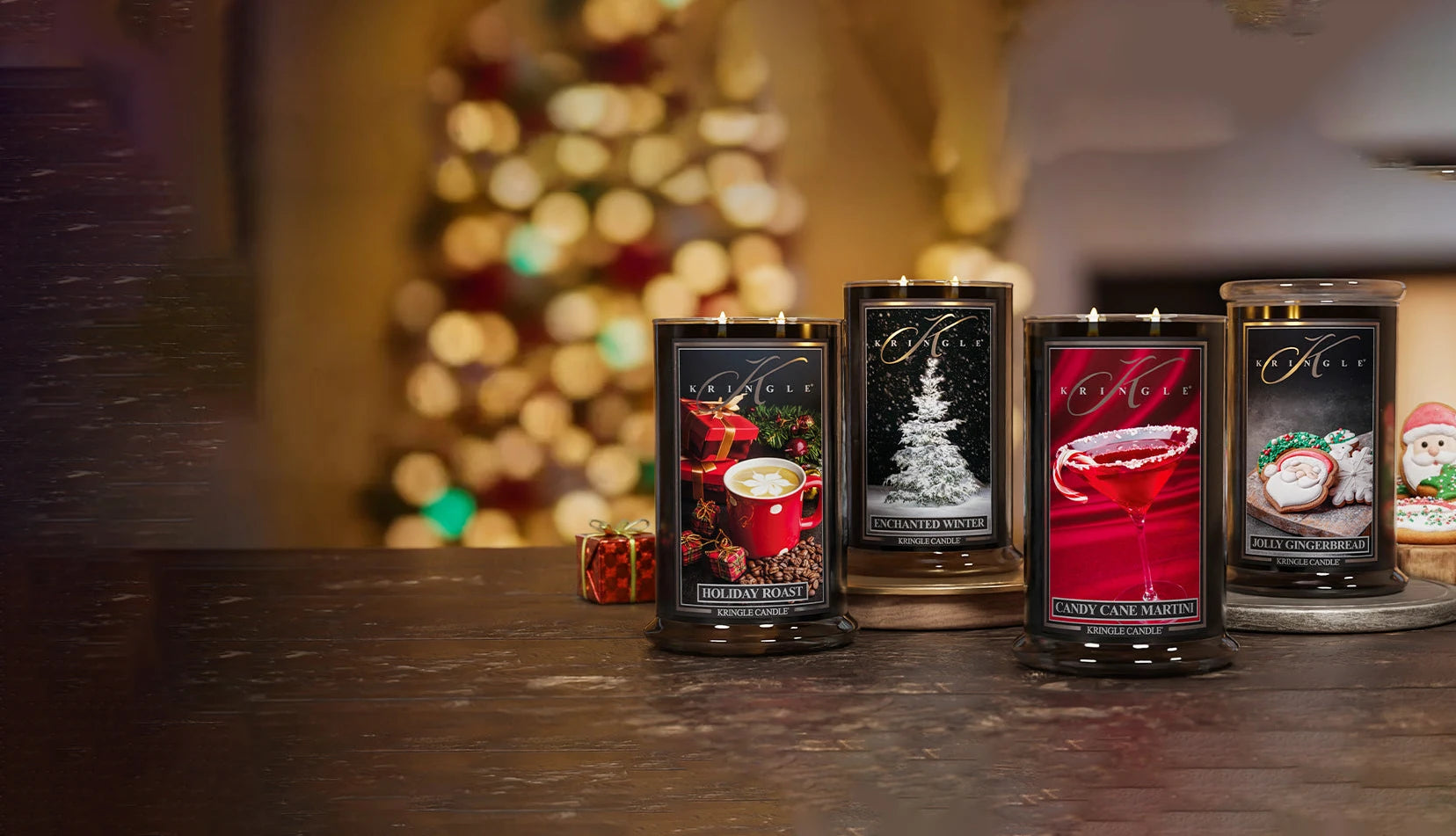 Four candles with decorative labels on a table with a blurred festive background