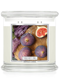 Unlit XL 4-Wick "Velvet Fig" candle with a label showing figs and a purple cloth.