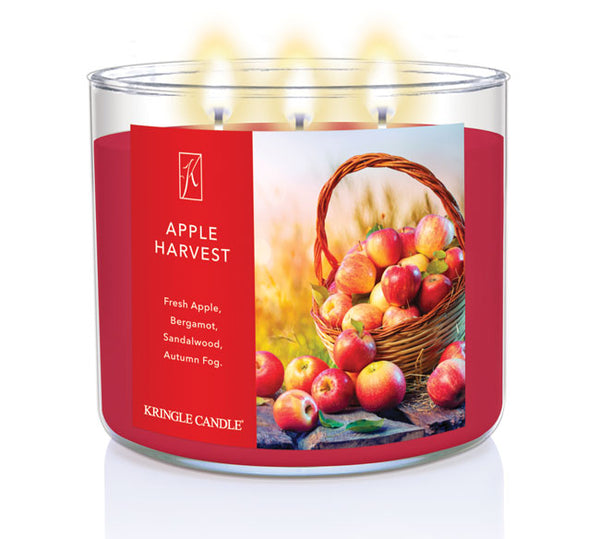 Kringle Candle Apple Harvest candle with a red label featuring apples and wheat.
