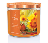 Kringle Candle Autumn Bloom candle with sunflower and pumpkin design on an orange label.