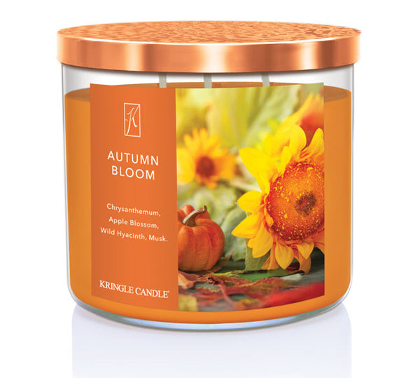 Kringle Candle Autumn Bloom candle with sunflower and pumpkin design on an orange label.