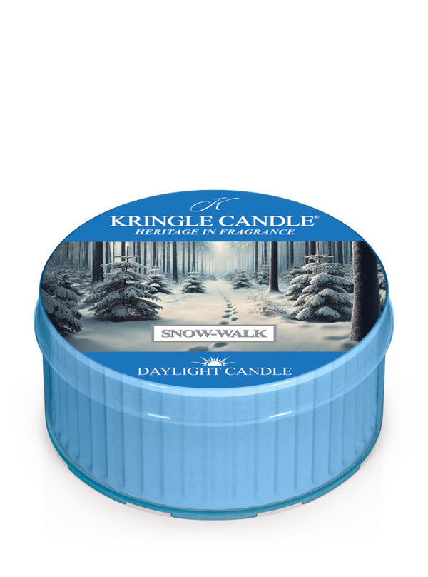 Kringle Candle daylight in blue labeled "Snow-Walk Daylight." Lid features a snowy forest path under a clear sky.