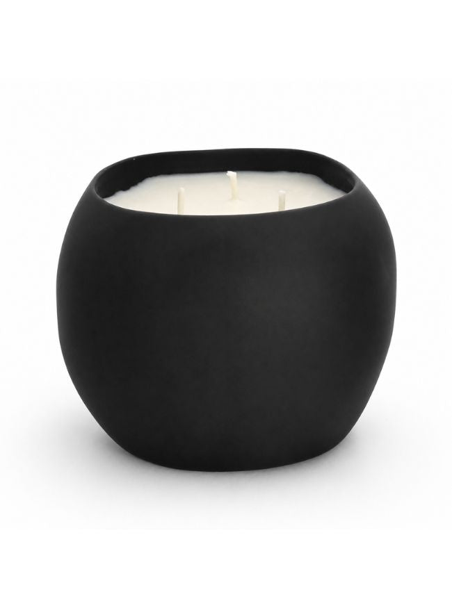 A matte black round candle pot with three white wicks and white wax, photographed on a clean white background.