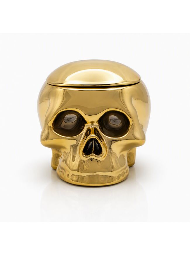 A shiny metallic gold skull-shaped container with a hinged lid, photographed on a clean white background.