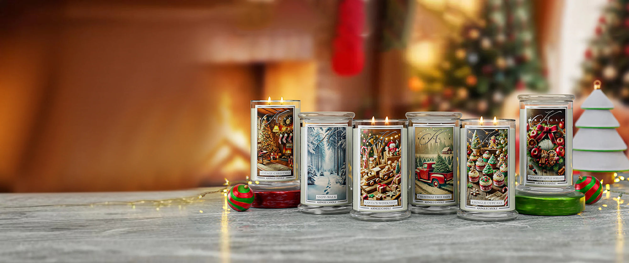 Set of Christmas-themed candles on a table with a festive background
