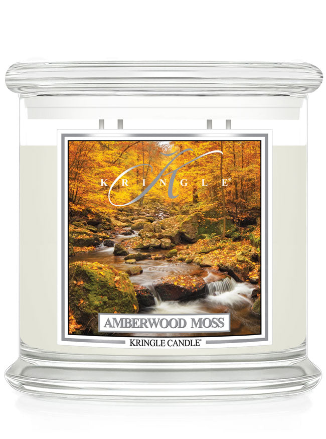 Unlit XL 4-wick candle jar with a label showing a forest scene with a stream and autumn leaves in vibrant orange hues.