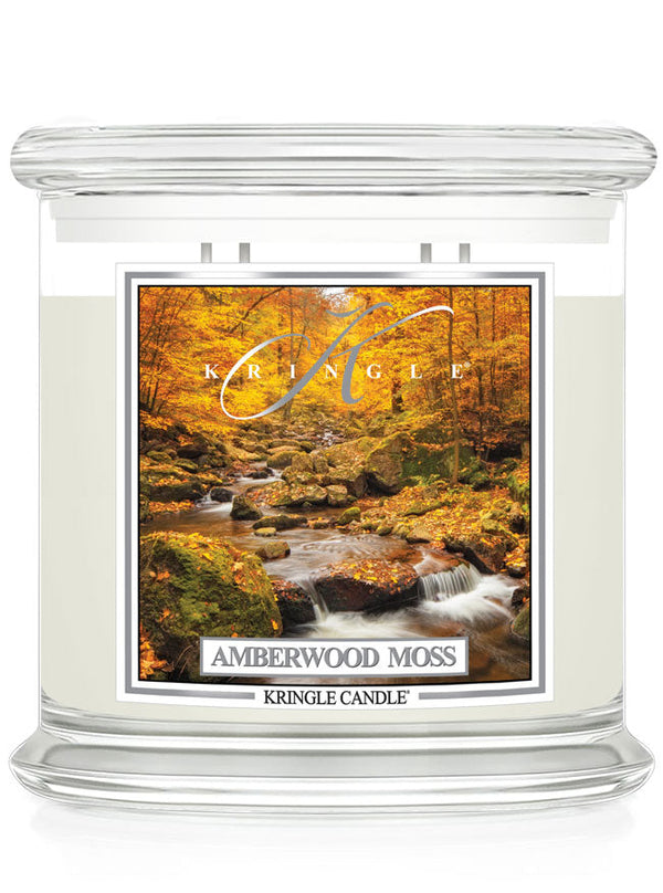 Unlit XL 4-wick candle jar with a label showing a forest scene with a stream and autumn leaves in vibrant orange hues.