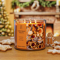 Candle with gingerbread men design and 'Christmas Treats' label on a wooden surface.