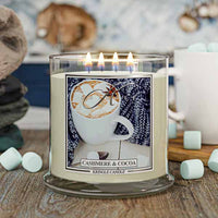Kringle Candle with 'Cashmere & Cocoa' label featuring a cup and scarf design, surrounded by marshmallows.