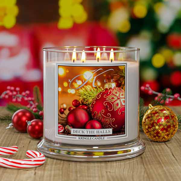 Kringle Candle Christmas-themed candle with festive decorations in the background