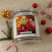 Kringle Candle 'Deck the Halls' on a wooden surface with Christmas decorations.