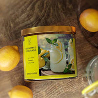 Candle labeled 'Grandma's Lemonade' with lemons around on a wooden surface
