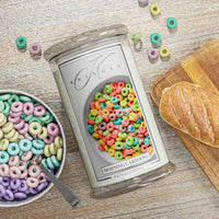 Kringle Candle with colorful cereal design on a table with cereal and bread
