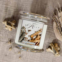 Kringle Candle with 'Sage & Palo Santo' label on a textured surface