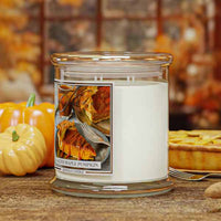 Candle jar with a pie-themed label on a wooden surface with pumpkins and pies in the background