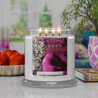 Kringle Candle with 'Sugar Plum & Myrrh' fragrance on a surface with decorative items in the background.