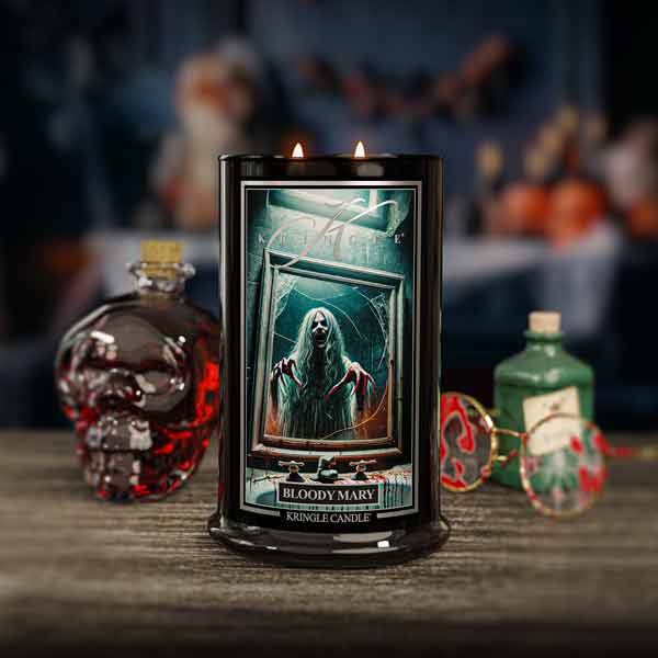 Candle labeled 'Bloody Mary' with a bottle and decorative elements in the background