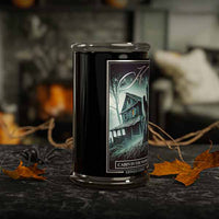 Candle with a 'Cabin in the Woods' label on a dark surface with autumn leaves
