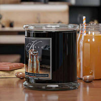 Black candle with a label on a wooden surface