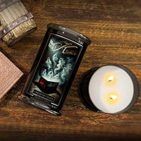 Candle with a Halloween decorative label on a wooden surface