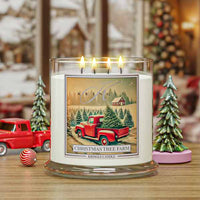 Kringle Candle with Christmas tree farm design featuring a red truck and trees on a snowy background.