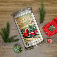 Kringle Candle Christmas Tree Farm candle with decorative elements on a wooden surface