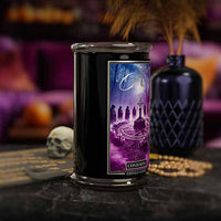 Decorative candle  titled Conjuring with a purple label featuring an illustration of a witch and moon, on a dark surface with a blurred background.
