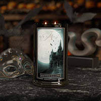 Haunted Hallows Candle with a haunted castle design on a dark background
