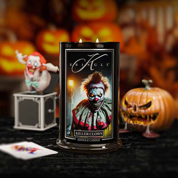 Kringle Candle with a clown design in front of Halloween-themed decorations
