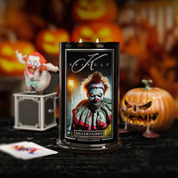 Kringle Candle with a clown design in front of Halloween-themed decorations