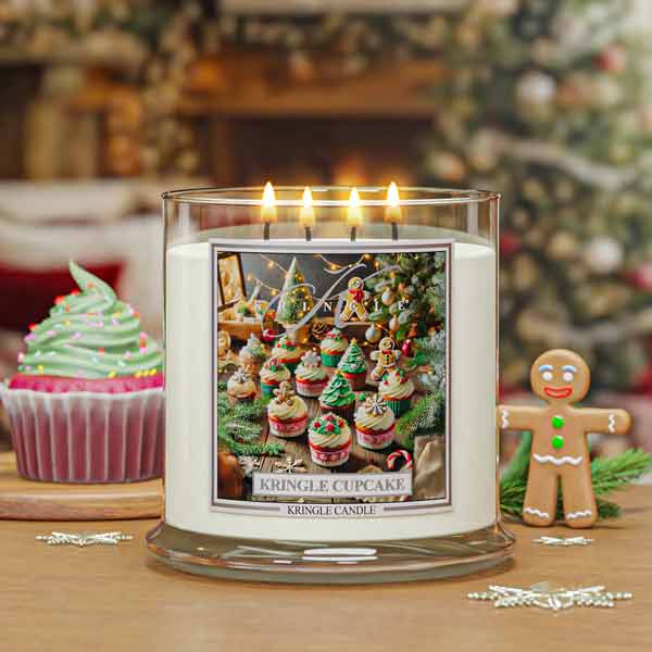 Kringle Candle with festive design and Christmas-themed items on a wooden table.