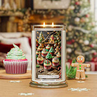Christmas Cupcake Kringle Candle with Christmas-themed design in front of a decorated Christmas tree