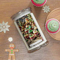Christmas Cupcake Kringle Candle with Christmas cupcake design on a wooden surface with festive decorations.
