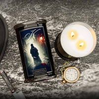 London Fog Halloween Candle with a decorative label on a textured surface, accompanied by a lighter and pocket watch.