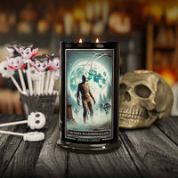 Kringle Candle mummy marshmallow candle with Halloween-themed decorations on a wooden surface.