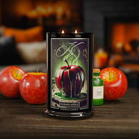 Kringle Candle Poison Apple candle with apples and a bottle in the background
