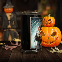 Halloween-themed candle with pumpkins and a ghostly label on a wooden surface.
