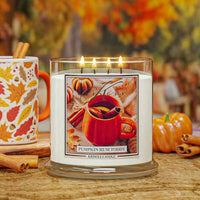Candle labeled 'Pumpkin Rum Toddy' with a mug and pumpkins in the background