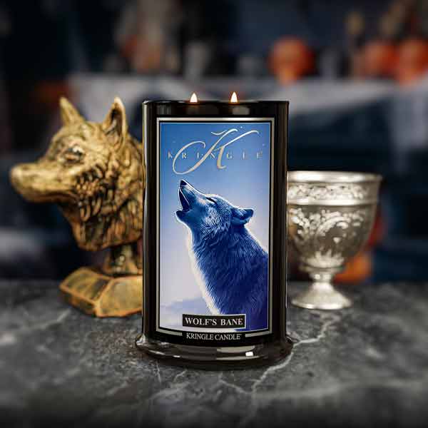 Kringle Candle with wolf design on a dark surface.