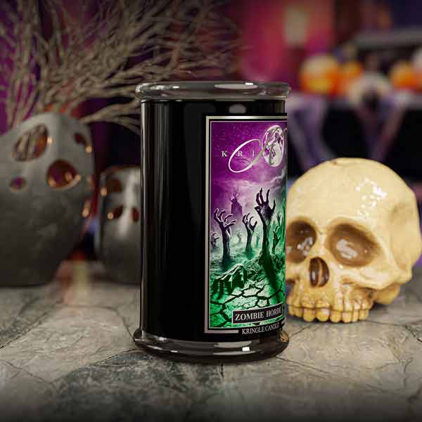 Candle with 'Zombie Horde' label in front of Halloween-themed decorations