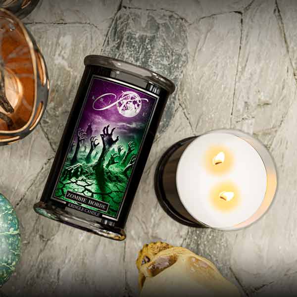 Candle with a zombie-themed label on a textured surface