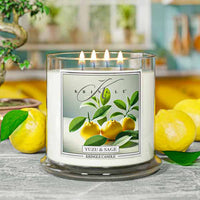 Kringle Candle with yuzu and sage design on a table with lemons