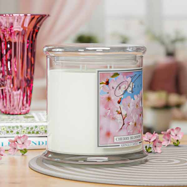 Kringle Candle cherry blossom 4-wick lit candle on a table with a blurred background