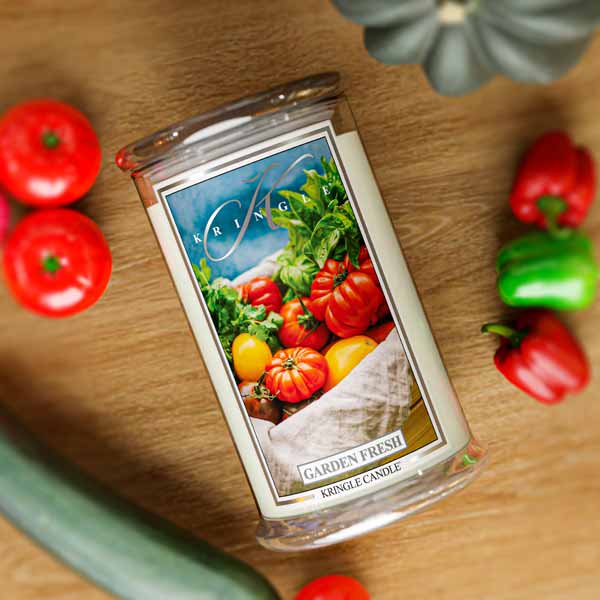 Clear jar candle labeled "Garden Fresh" with an image of assorted tomatoes and greens on the front.