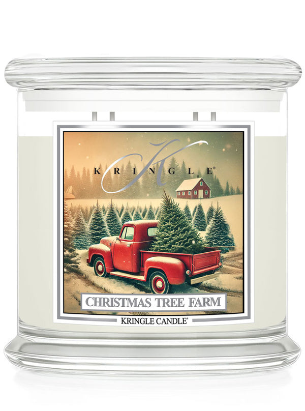 Kringle Candle 4-wick jar with "Christmas Tree Farm" label featuring a red truck in a snowy pine forest scene.