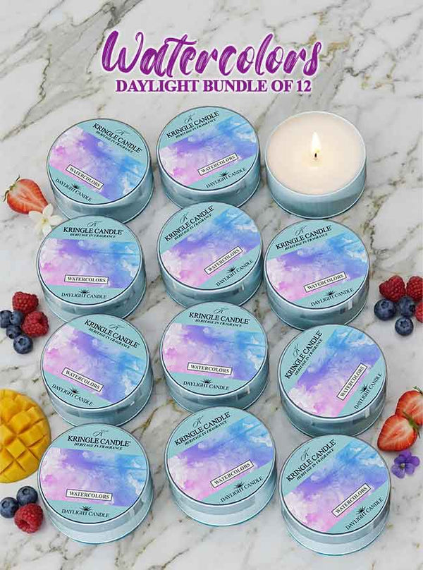 12 Kringle Candle Watercolors Daylight candles on a marble surface with berries around.